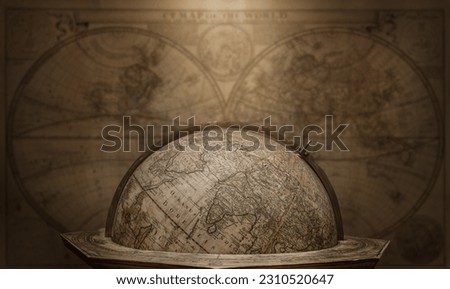 Old geographical globe on map background. Science, education, travel, vintage background. History and geography team. Ancience, antique globe on the background of books.