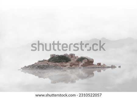 A Greek tiny island, with a great water reflection, lost in the mist, Athens, Greece Royalty-Free Stock Photo #2310522057