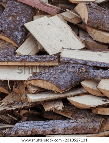 wooden firewood for fireplace and heating of country house. harvesting of wood for cold winter season. no people photo of textured wood chips, closeup. garden farm