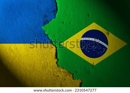 Ukraine flag and Brazil flag painting on wall. Ukraine vs Brazil