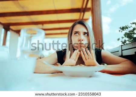 
Woman Refusing to Eat her Meal Feeling Full. Customer sending the dish back unhappy with the serving 
 Royalty-Free Stock Photo #2310558043