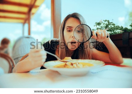 
Picky Eater Inspecting Soup with Magnifying Glass. Perfectionist woman checking her meal for any wrong details
 Royalty-Free Stock Photo #2310558049