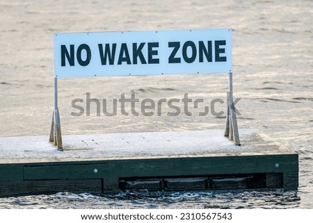 No Wake Zone sign floating on water