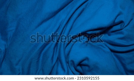 the texture of the folds and waves of the fabric in blue