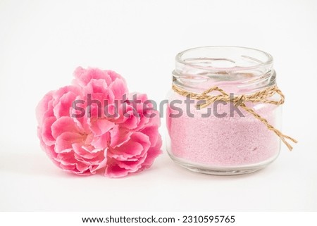 Damask rose flower and salt isolated on white background.