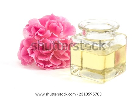 Damask rose flower and oil isolated on white background.