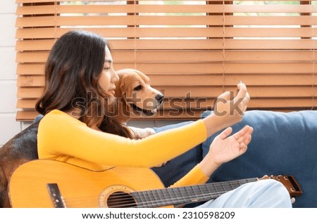 Beagle dog joining the owner's selfie on the sofa in the living room of the house