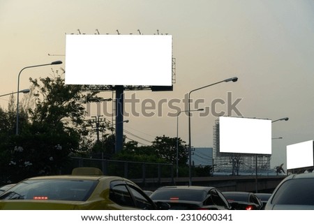 Blank template for outdoor advertising or blank billboard on highway at dusk with clipping path on screen - can be used for trade shows, and advertising or promotional posters.