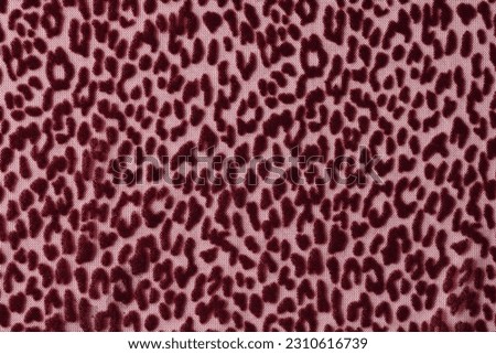 Pink fabric with dark sports pattern designed for blankets plaids and towels. Soft textile material texture as background. Catalog photo sample