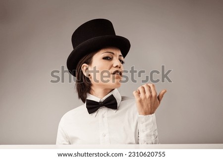 Arrogant woman with top hat blowing nail polish. Confident and captivating, yet full of conceit. Self-proclaimed as the best Royalty-Free Stock Photo #2310620755
