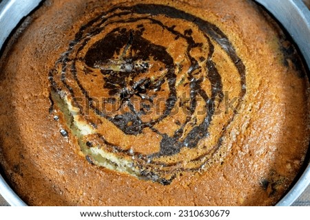 Tiger marbled sponge cake, components of flour, butter, oil, vanilla powder, cacao, sugar, milk, eggs and baking powder, striped spongy delicious sweet baked cake ready to be served with a drink