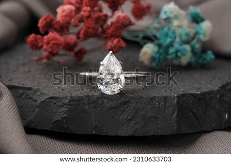 Diamond engagement ring isolated on black stone, Diamond ring for girls  Royalty-Free Stock Photo #2310633703