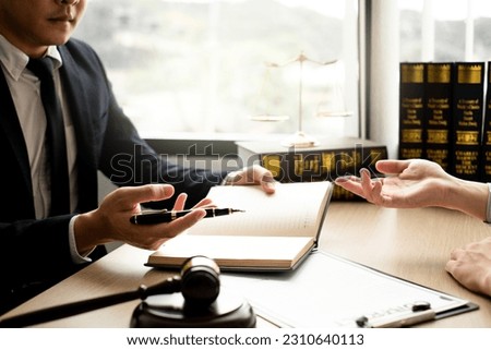 The lawyer and client discuss the lawsuit, analyze facts, explore legal options, and plan their strategy together. Royalty-Free Stock Photo #2310640113