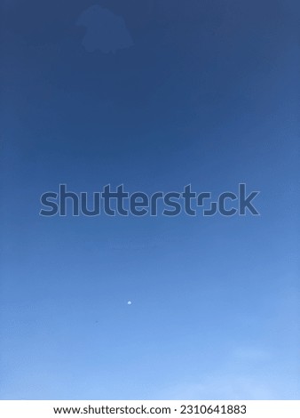 Evening blue sky with small moon
