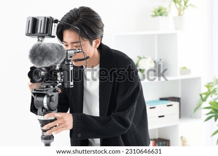 Asian cameraman shooting a video