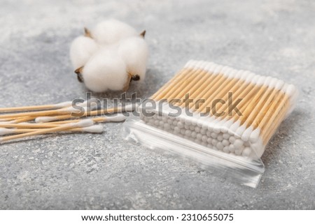 White cotton swabs on a blue textured background. Cotton buds. Bamboo cotton buds. Eco friendly. Hygienic cotton swabs for ears. Place for text. Place to copy. Royalty-Free Stock Photo #2310655075