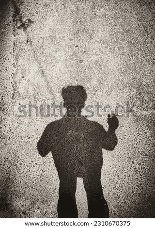 A shadow of a person on a wall.