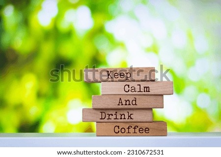 Wooden blocks with words 'Keep Calm And Drink Coffee'. Inspirational motivational quote