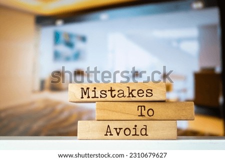 Wooden blocks with words 'Mistakes To Avoid'.