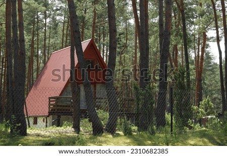 A brda type holiday cottage in the forest Royalty-Free Stock Photo #2310682385