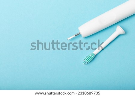Sonic electric toothbrush on a blue background. Oral hygiene. Dental care. Dentistry concept. Place for text. Place to copy.