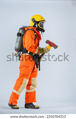 The firefighter exudes unwavering confidence as he stands sideways firmly clutching an iron axe against his abdomen poised with his unwavering commitment all set against a pristine white background.