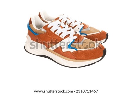 New brown shoes or sneakers isolated on white background with clipping path. High quality photo