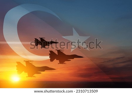 Aircraft silhouettes on background of sunset with a transparent Turkey flag. Turkish Air Force aerobatic demonstration. Air Force Day. Turkish Air Force Foundation Day. Royalty-Free Stock Photo #2310713509