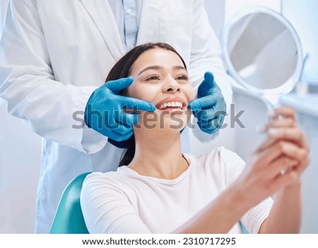 Dental consultation, mirror and woman with smile after teeth whitening, service or mouth care. Healthcare, dentistry and happy female patient with orthodontist for oral hygiene, wellness and cleaning Royalty-Free Stock Photo #2310717295