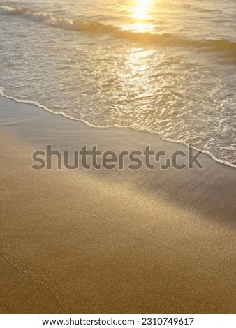 Sunshine reflection on the sandy sea coastline, golden hour, wat sea sand, evening sunlight on the sea shore 