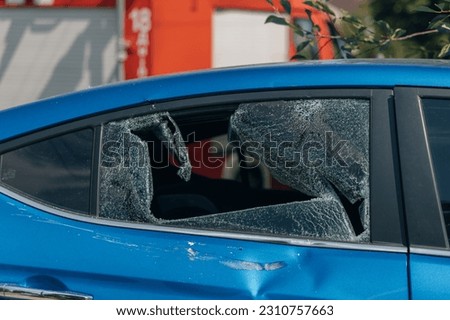 Broken windshield and side glass in the car. Close-up. The blue color of the car. Problem. Glass replacement. accident