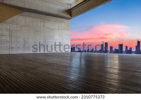Plank platform and city skyline at sunset