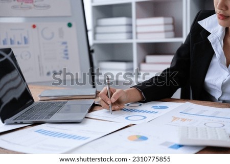 Asia stock trader agent or Sale tax loan broker advice brief and point hand to graph report talk to client at office desk show budget chart data or legal result on claim form. Trust will in work plan. Royalty-Free Stock Photo #2310775855
