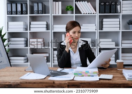 Beautiful young teen asian businesswoman using computer and smartphone mobile with planning working on financial document, tax, exchange, accounting and Financial advisor