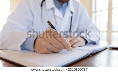 Doctor handwriting. Close up view of male physician surgeon general practitioner hand filling paper forms and medical journals after accepting patients, making records to cards and treatment profiles Royalty-Free Stock Photo #2310800787
