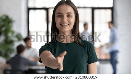 Head shot portrait pretty friendly employer stretch out her hand for hand shake greets applicant, representative of company young confident executive manager welcoming client express respect concept Royalty-Free Stock Photo #2310800819