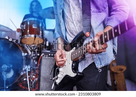Guitar, band and man hands at music festival show playing rock with electric instrument with lights. Sound, musician and party with live talent and audio for punk event with people at a concert