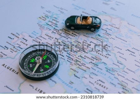 Travel to Europe or European countries concept photo. Compass and a toy car on the Europa map.