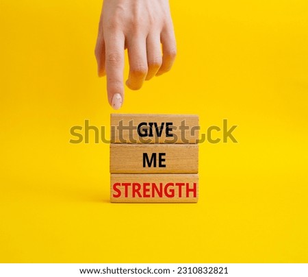 Give me strength symbol. Concept word Give me strength on wooden blocks. Businessman hand. Beautiful yellow background. Business and Give me strength concept. Copy space
