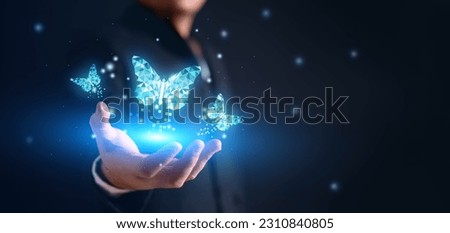 Blue Digital Butterfly effect on the businessman with glowing particles light. Global business economy and digital transformation concept. Connectivity and Virtual Reality theme. Copy space Royalty-Free Stock Photo #2310840805