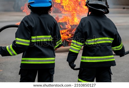Firefighters with their backs trying to put out a fire