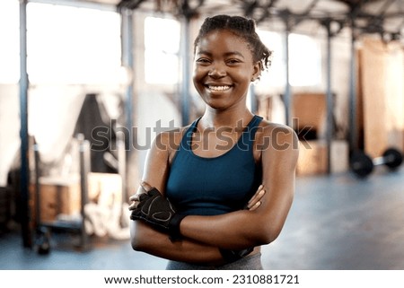 Happy black woman, portrait smile and fitness with arms crossed for workout, exercise or training at the gym. Fit, active or sporty African female person or athlete smiling for healthy wellness Royalty-Free Stock Photo #2310881721