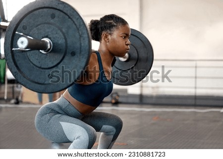 Fitness, weightlifting and barbell with black woman in gym for workout, strong and muscle. Health, challenge and exercise with female bodybuilder and weights for focus, performance and commitment Royalty-Free Stock Photo #2310881723