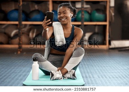 Phone, selfie and black woman fitness influencer on social media on a cellphone during workout or exercise in a gym. Health, wellness and young person or athlete happy online, internet or web