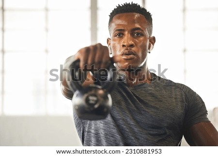 Kettlebell, fitness and black man with gym workout, bodybuilder challenge and training with health and focus. Young athlete or professional person sweating for sports exercise, muscle and power goals Royalty-Free Stock Photo #2310881953