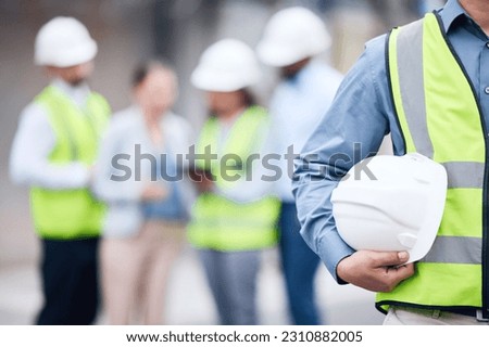 Businessman, architect and helmet for safety in construction, project management or meeting on site. Man holding hard hat for industrial architecture, teamwork or maintenance and building in the city Royalty-Free Stock Photo #2310882005