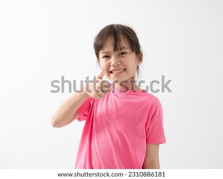 Photo of young little girl happy positive smile show thumb-up like fine recommend ad isolated over white background