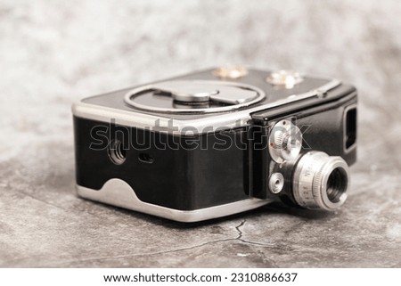 Vintage movie camera on a gray background.