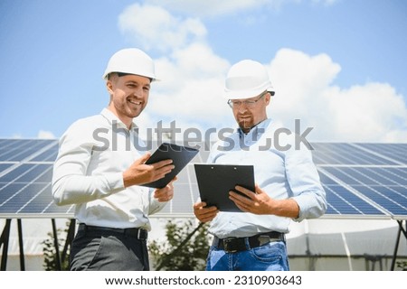 engineer and businessman planing new ecology project. around solar panel.