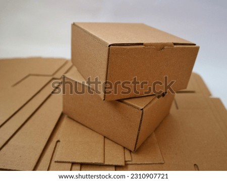 Heap of Brown cardboard or paper box on the top of die cut paper box isolated on white background. Mock up, copy space. Royalty-Free Stock Photo #2310907721